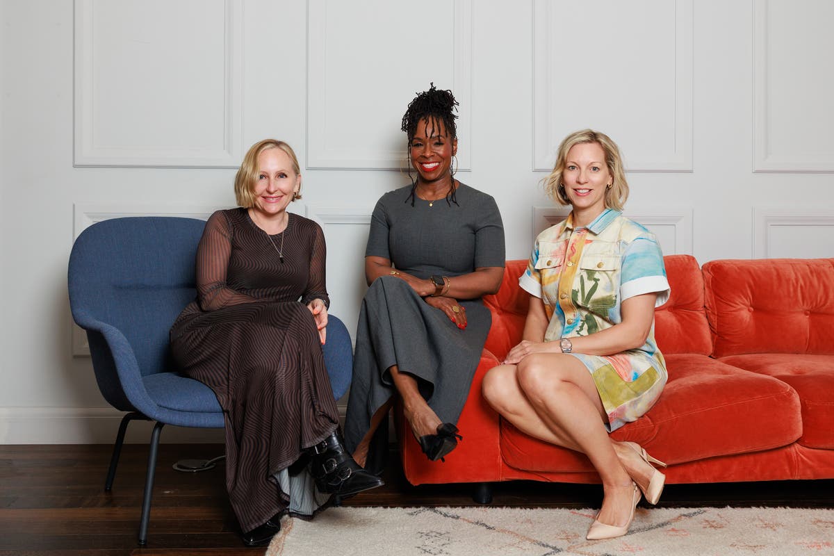 Emma Harman, Ndidi Oteh and Jo Cronk sit together on blue and orange chairs in the Whalar acquisition announcement photograph.
