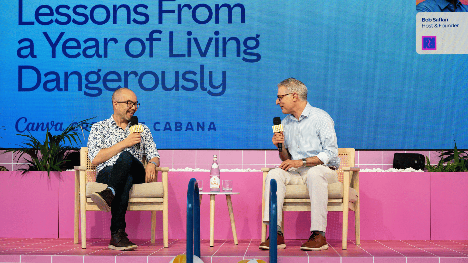Cameron Adams and Bob Safian seated on a brightly lit Canva stage at Cannes 2026.